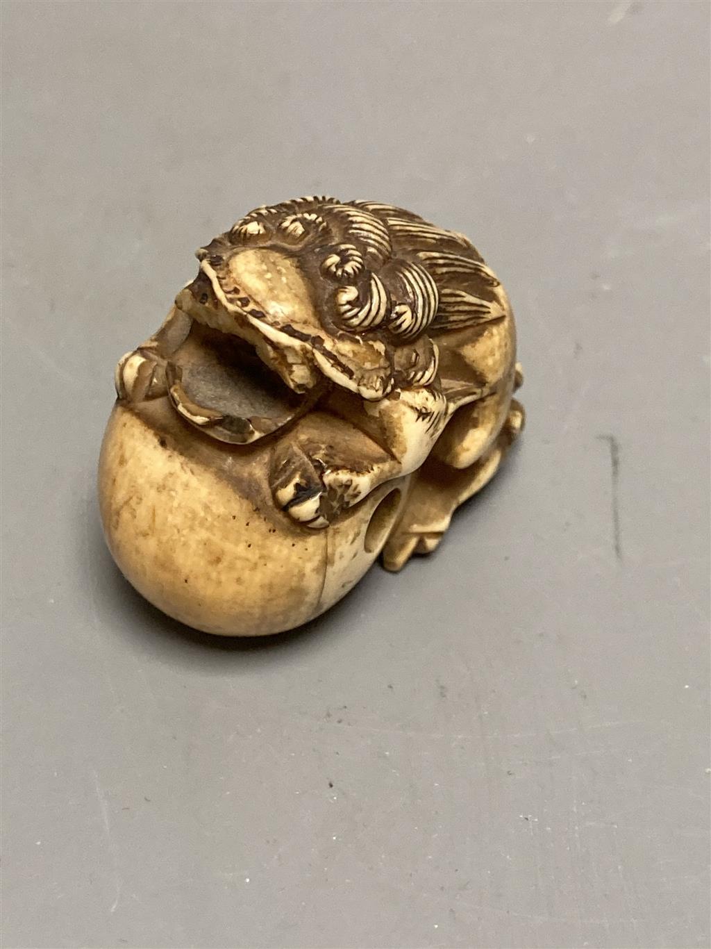 A 19th century Chinese carved ivory needle case, a damaged netsuke and a small cloisonne box
